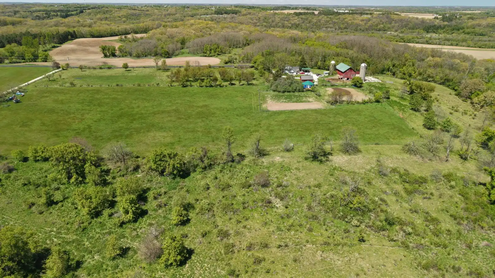 Wide drone view across the 35-acre Goldstein Farm and the surrounding Walworth County countryside, Wisconsin