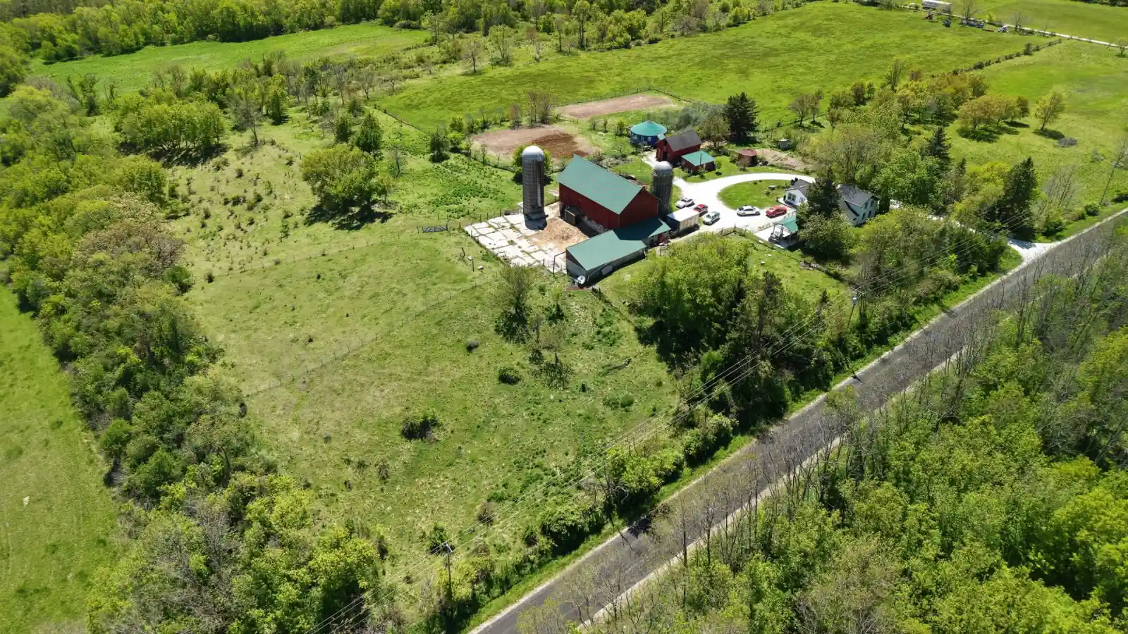 The Goldstein Farm farmstead and pasture behind a wooded fence line along Kniep Road, Town of Spring Prairie, Wisconsin