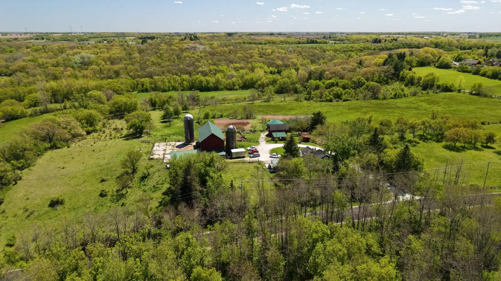 The Goldstein Farm farmstead set into rolling wooded hills of southeastern Wisconsin near Lake Geneva
