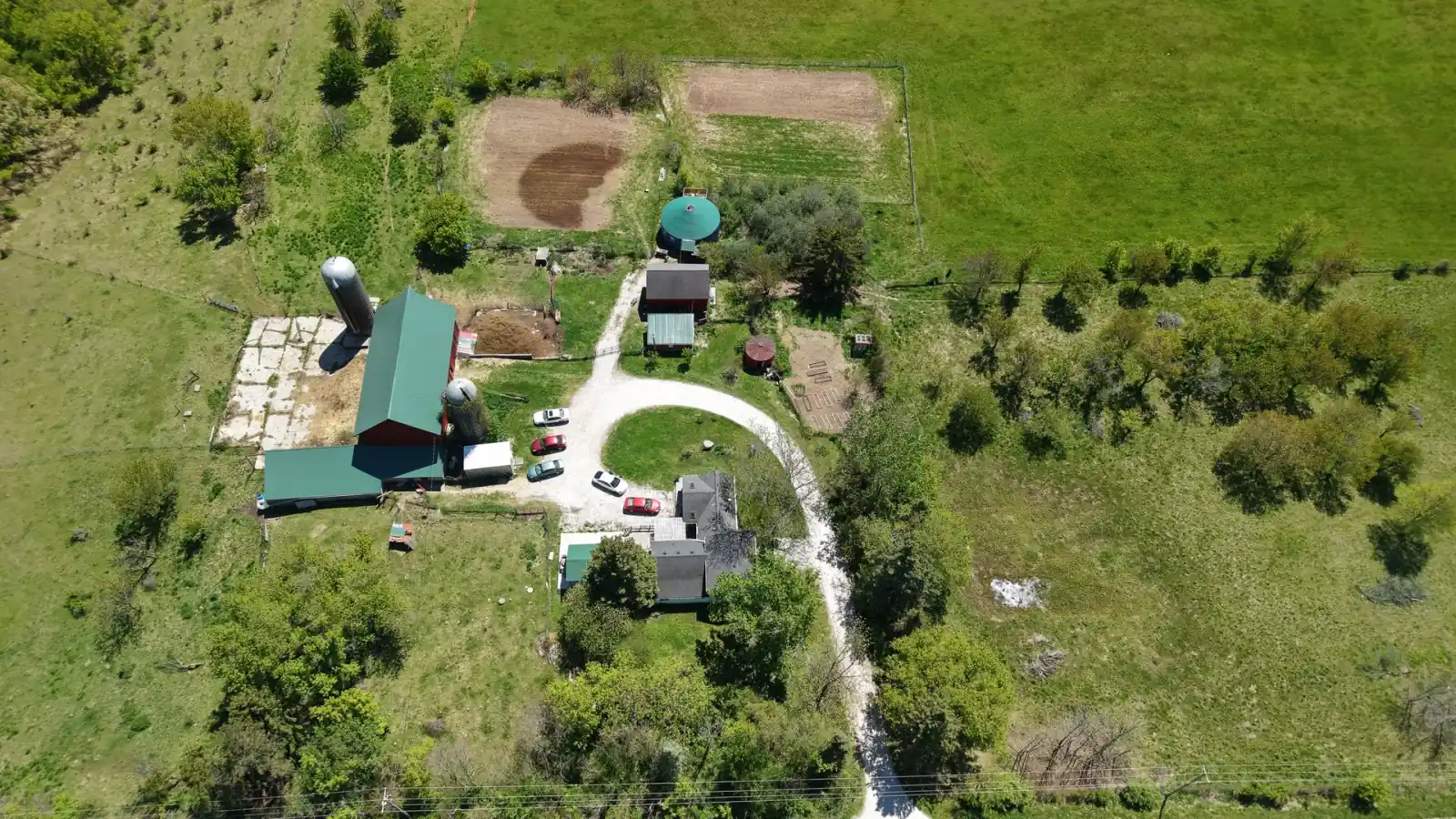 Overhead view of the Goldstein Farm farmstead: red barn, silo, heated yurt, garden plots and circular drive, Spring Prairie, Wisconsin