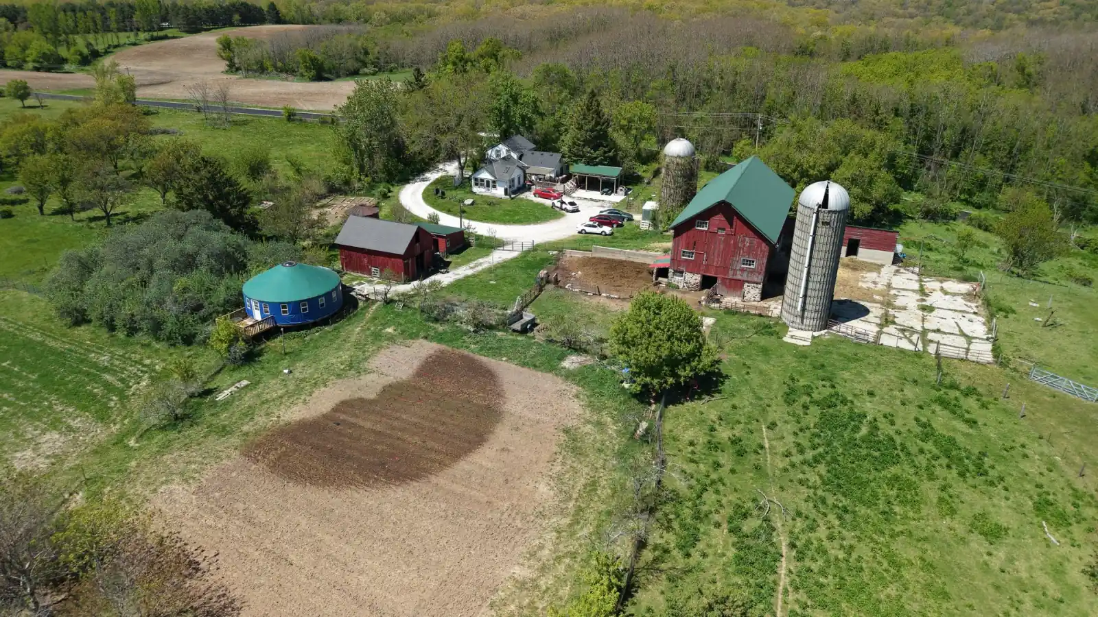 Heated yurt, red barn, two silos and a large garden plot at the Goldstein Farm, Walworth County, Wisconsin