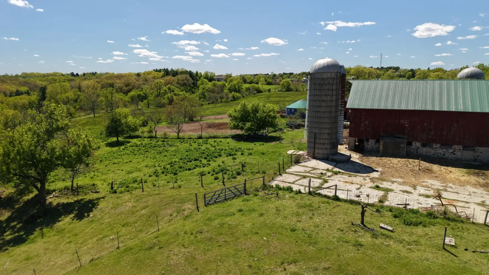 Silo and red barn with pasture fencing on a clear May day at the Goldstein Farm, Spring Prairie, Wisconsin